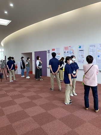 2022.05.20_写真③学生ボランティアから来場者へ1年生展示物の説明